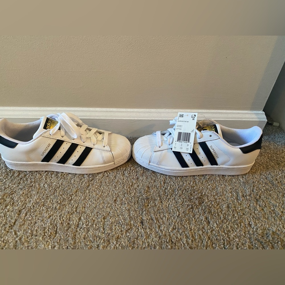 Women’s size 6.5 white and black adidas superstar sneakers.